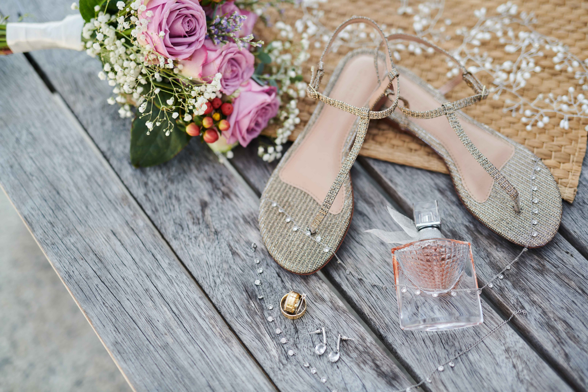 The details of accessories at a Koh Tao wedding with shoes, perfume, jewellery and flowers.