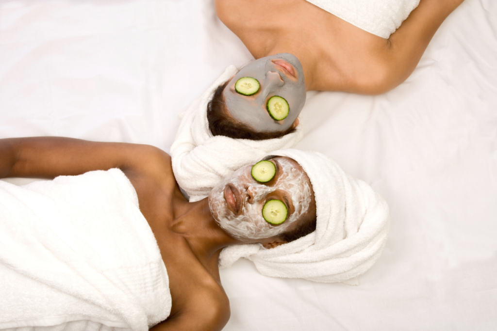 Spa Day - two women lying down with face masks and cucumbers on eyes enjoying a pampering spa day.